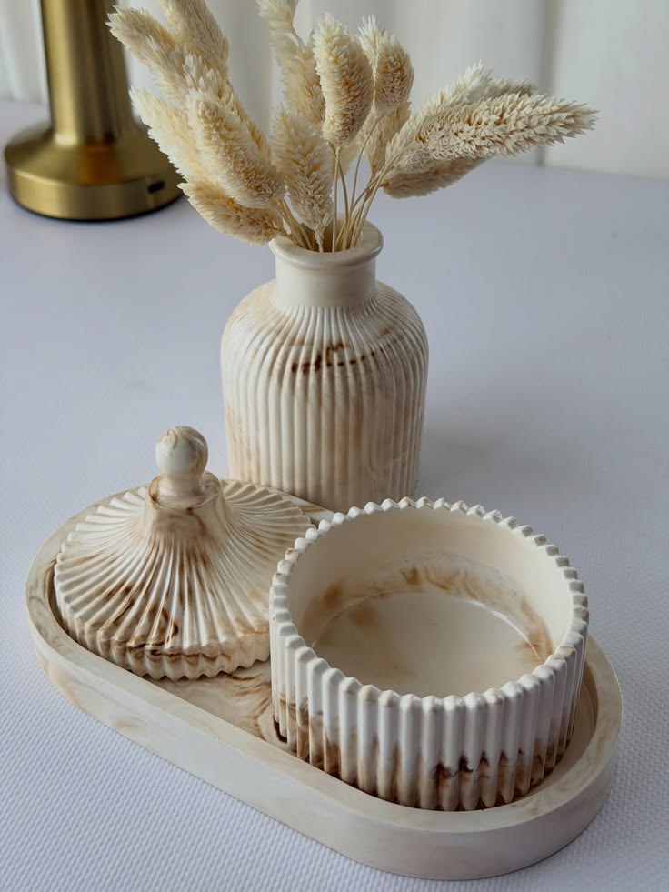 Black home decor pieces with gold accents arranged on a round table