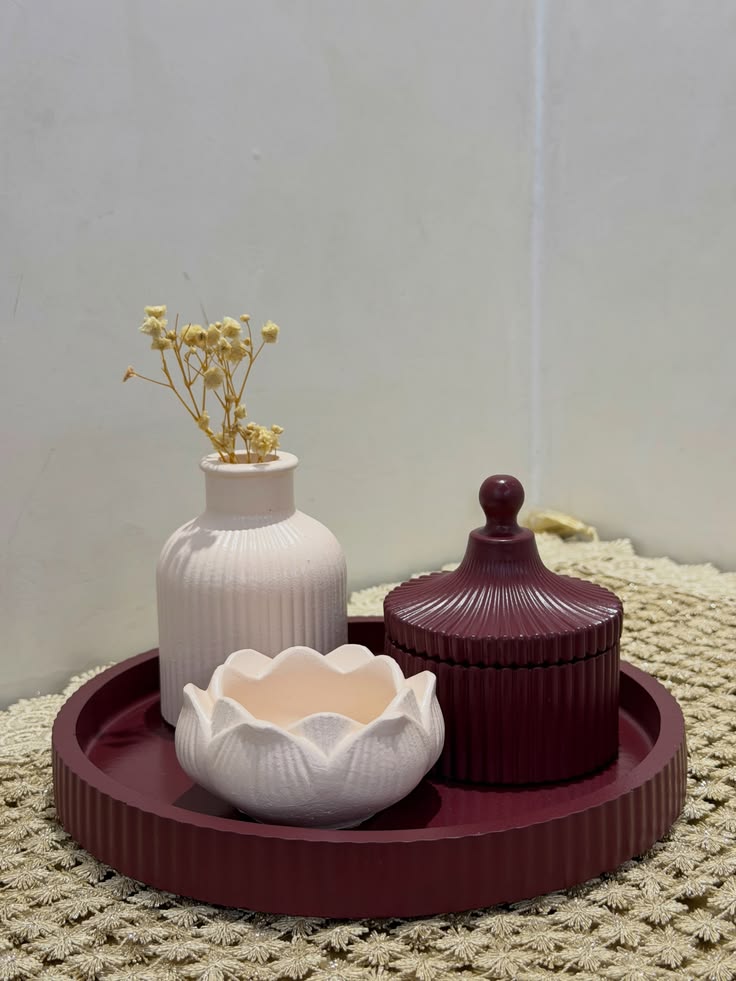 Berry and ivory decorative objects curated on a tray