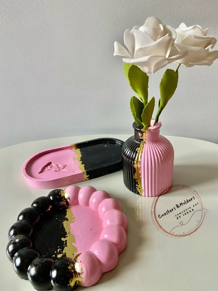 Pink and black colour-block coasters with matching vases and tray