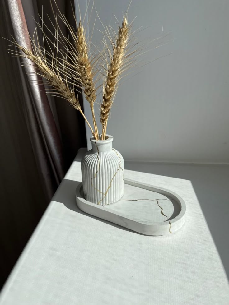 Ivory vase and tray with dried wheat