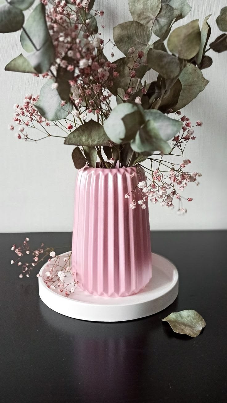 Pink fluted vase arranged with eucalyptus and dried flowers