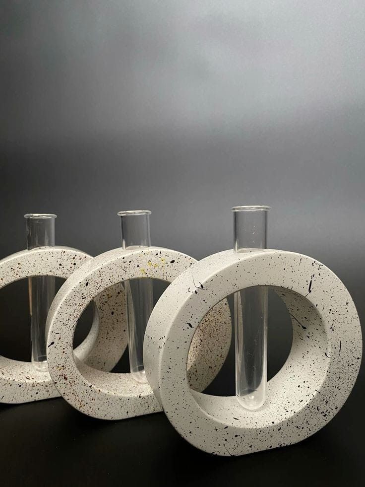 Three ivory speckled ring vases with clear glass stem tubes